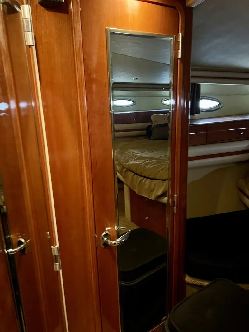 Slide: The Image of Interior cabin of a 2001 Sea Ray 56 Sedan Bridge yacht with wooden door and mirror. - 11