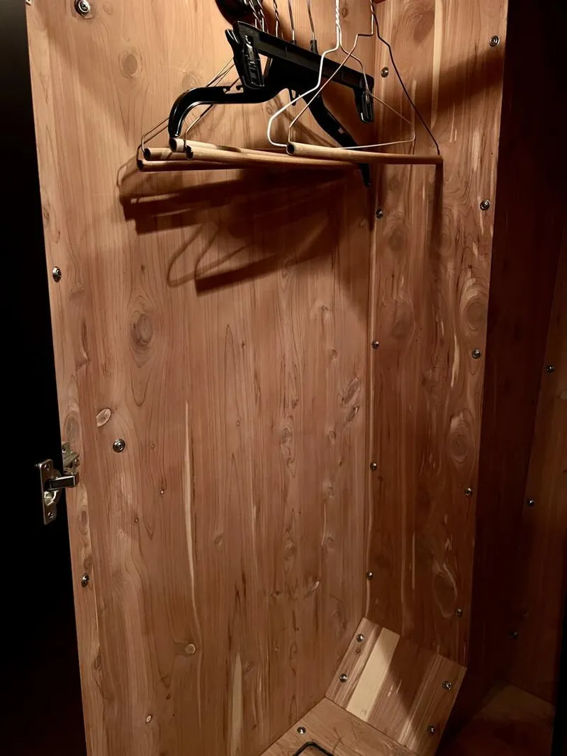 Slide: The Image of Wooden closet interior with hangers on a 2001 Sea Ray 56 Sedan Bridge yacht. - 18