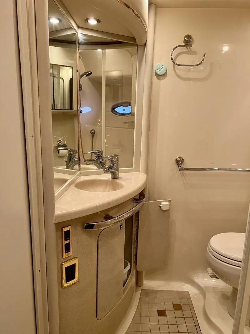 Slide: The Image of 2001 Sea Ray 56 Sedan Bridge bathroom with sink, mirror, and toilet. - 19