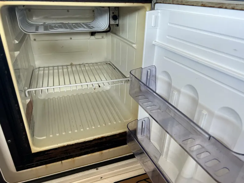 Slide: The Image of Empty refrigerator inside a 2001 Sea Ray 56 Sedan Bridge yacht. - 24