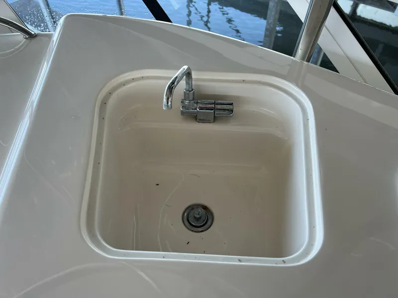 Slide: The Image of 2001 Sea Ray 56 Sedan Bridge sink with faucet on deck. - 27