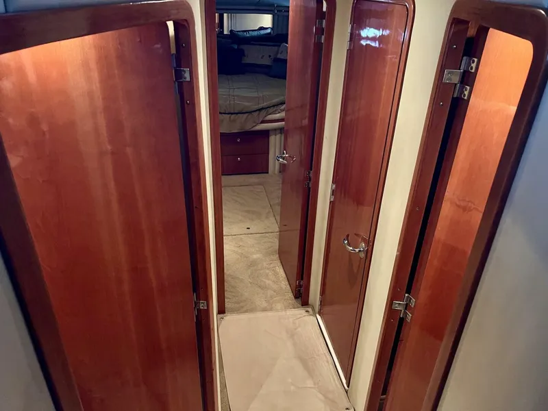 Slide: The Image of Interior hallway of 2001 Sea Ray 56 Sedan Bridge yacht with wooden doors. - 8