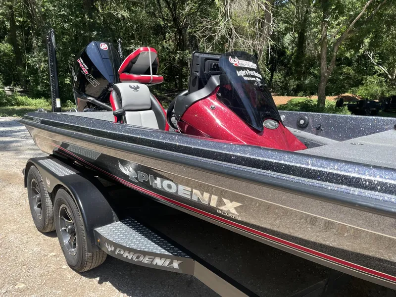 Slide: The Image of 2023 Phoenix 921 Elite II bass boat with dual consoles and red accents. - 10
