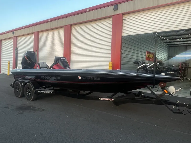 Slide: The Image of 2023 Phoenix 921 Elite II boat parked outside a storage facility. - 2