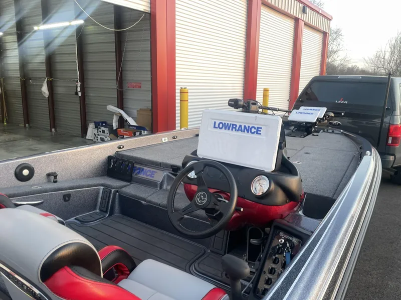 Slide: The Image of 2023 Phoenix 921 Elite II boat with Lowrance electronics at a storage facility. - 4