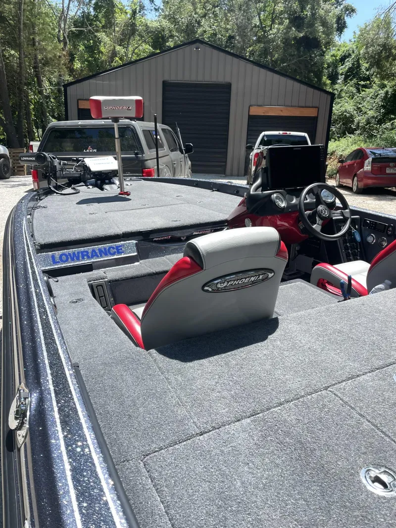 Slide: The Image of 2023 Phoenix 921 Elite II bass boat with Lowrance electronics in a driveway. - 8