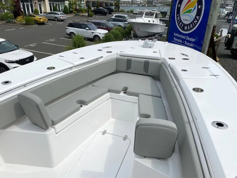 Slide: The Image of 2024 Cape Horn 34 XS boat with spacious seating area at a marina. - 10
