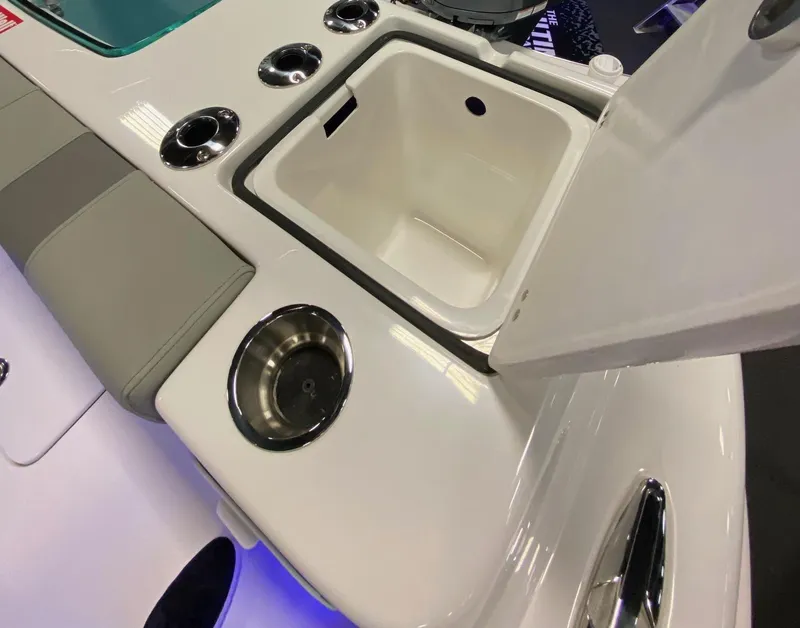 Slide: The Image of 2024 Cape Horn 34 XS boat with open storage compartment and cup holders. - 12