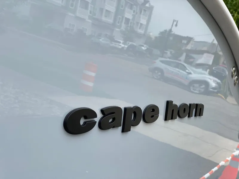 Slide: The Image of Cape Horn 34 XS 2024 model boat nameplate in urban setting. - 17