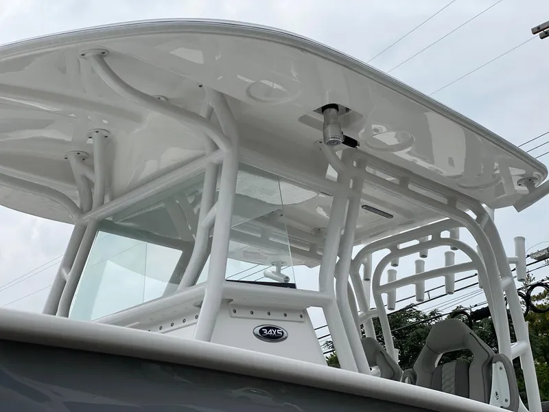 Slide: The Image of 2024 Cape Horn 34 XS boat, close-up of the helm and T-top structure. - 19