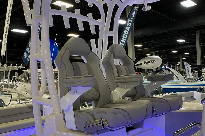 Slide: The Image of 2024 Cape Horn 34 XS boat interior with dual captain's chairs at a boat show. - 21