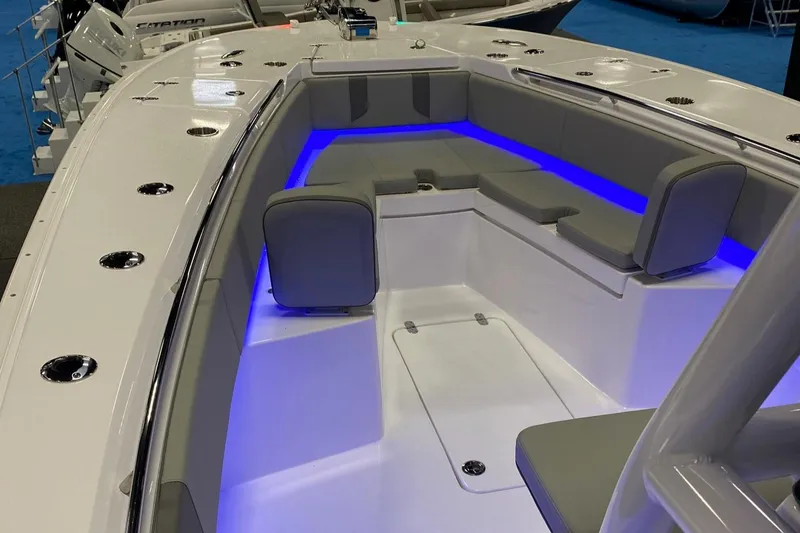 Slide: The Image of 2024 Cape Horn 34 XS boat interior with blue LED lighting and cushioned seating. - 25