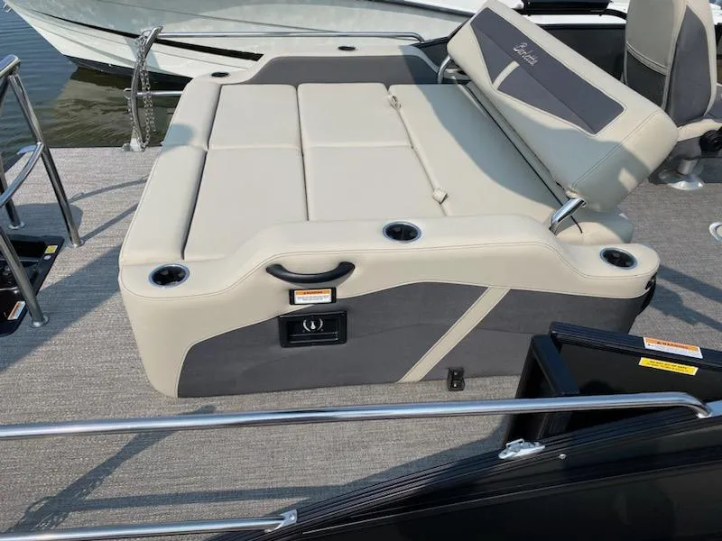 Slide: The Image of 2023 Barletta C22UC boat interior with beige seating and cup holders. - 2