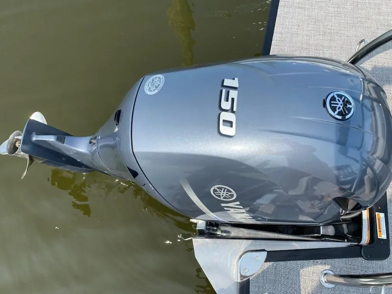 Slide: The Image of Yamaha 150 outboard motor on 2023 Barletta C22UC boat, docked on water. - 5