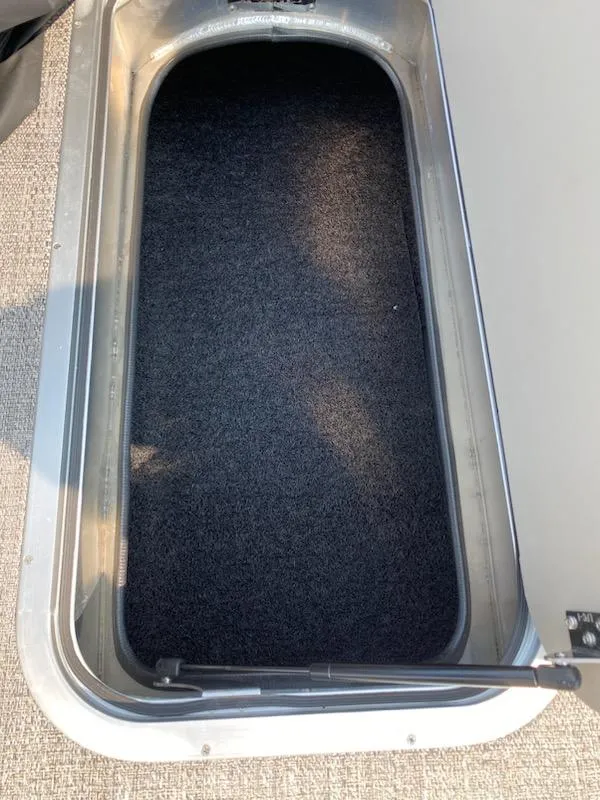 Slide: The Image of 2023 Barletta C22UC storage compartment with carpeted interior. - 6