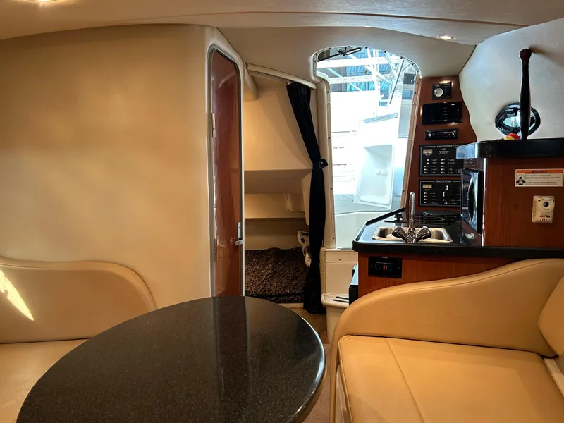 Slide: The Image of 2008 Regal 2665 Commodore boat docked in marina, calm water reflections. - 12