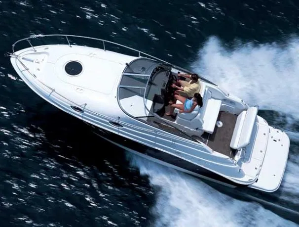 Slide: The Image of 2008 Regal 2665 Commodore boat docked in a marina, covered and sheltered. - 2