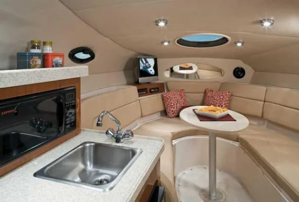 Slide: The Image of 2008 Regal 2665 Commodore boat docked in marina, white exterior, calm water. - 3