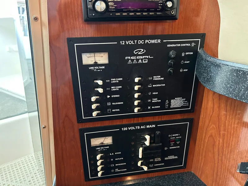 Slide: The Image of 2008 Regal 2665 Commodore boat docked with a person onboard, rear view. - 8