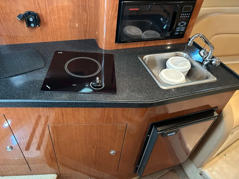 Slide: The Image of 2008 Regal 2665 Commodore boat docked in marina, calm water reflections. - 9