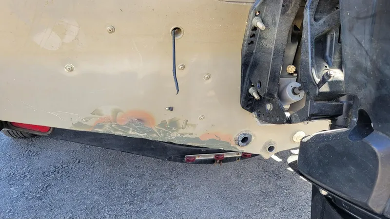 Slide: The Image of 2008 Lowe FS185 boat transom with visible damage and Mercury 150 engine mount. - 12