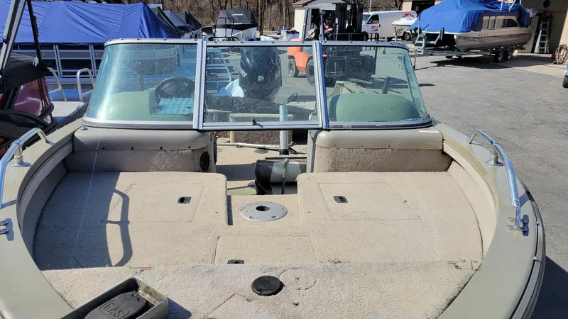 Slide: The Image of 2008 Lowe FS185 boat with walk-thru windshield, parked outdoors, featuring Mercury 150 engine. - 5