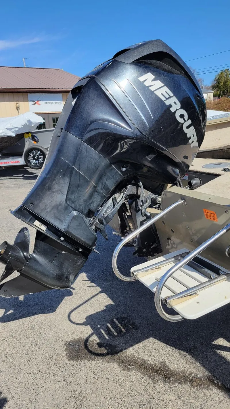 Slide: The Image of 2008 Lowe FS185 boat with Mercury 150 outboard motor, parked outdoors. - 6