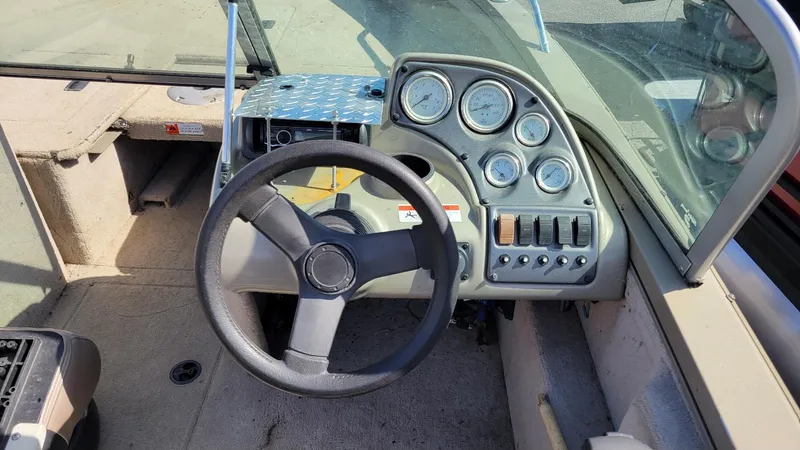 Slide: The Image of 2008 Lowe FS185 boat dashboard with steering wheel and gauges, featuring walk-thru windshield. - 7