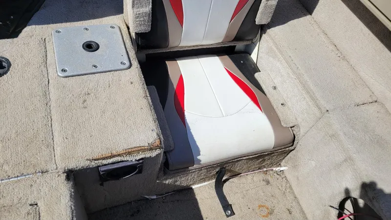 Slide: The Image of 2008 Lowe FS185 boat interior with red and white seating, carpeted flooring, and storage compartment. - 9