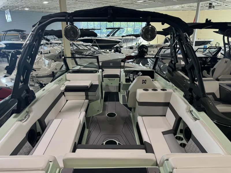 Slide: The Image of 2023 Heyday H22 boat interior with seating and speakers in a showroom. - 3