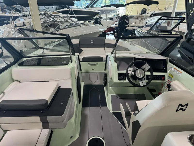 Slide: The Image of 2023 Heyday H22 boat interior with modern dashboard and seating in a showroom. - 6