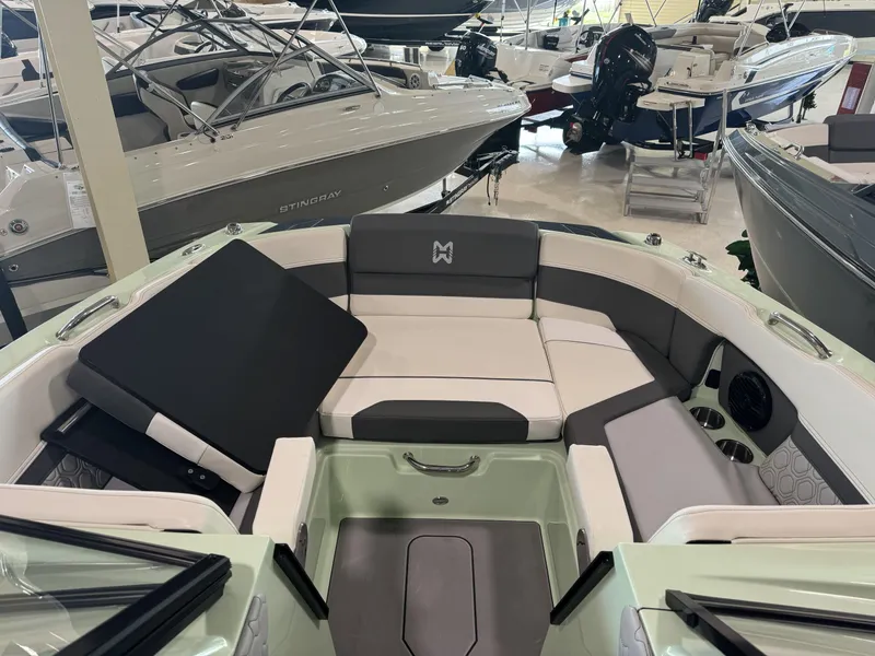Slide: The Image of 2023 Heyday H22 boat interior with seating and storage compartments in a showroom. - 8