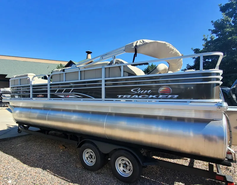 The Image of 2023 Sun Tracker SportFish 22 XP3 pontoon boat on a trailer. - 0