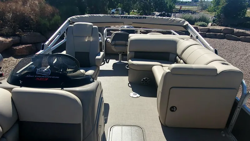 Slide: The Image of 2023 Sun Tracker SportFish 22 XP3 pontoon boat interior with beige seating. - 4