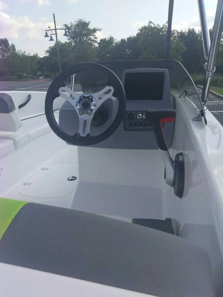 Slide: The Image of 2023 Tahoe T16 boat cockpit with steering wheel and control panel. - 2