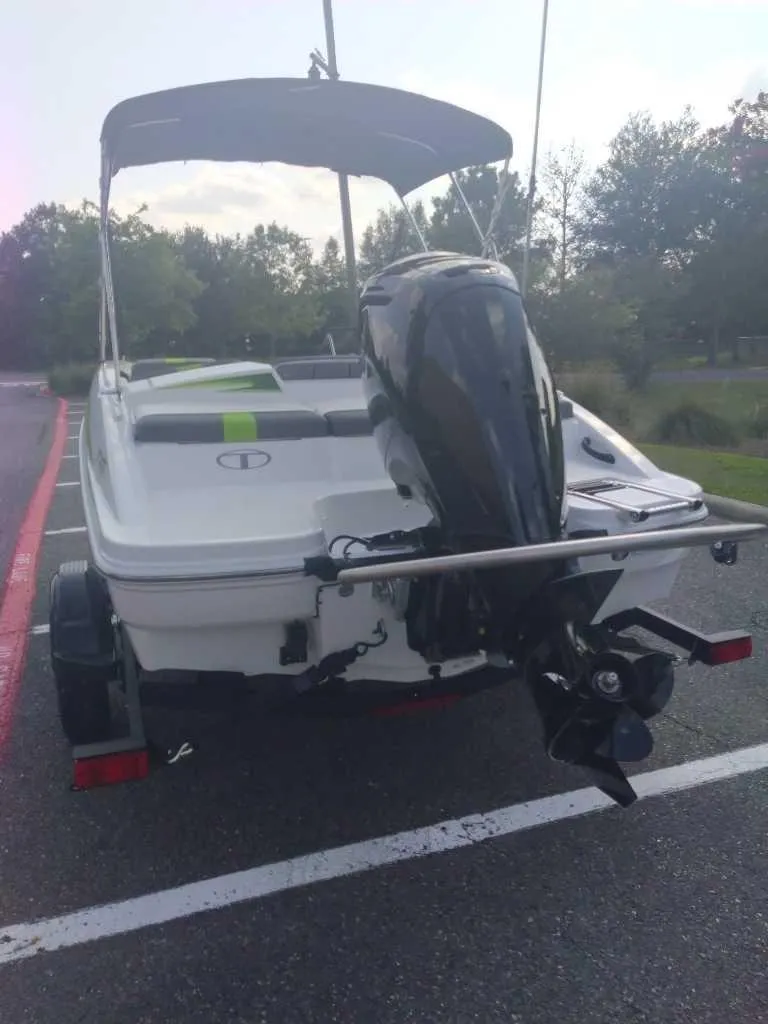 Slide: The Image of 2023 Tahoe T16 boat with outboard motor in parking lot. - 3