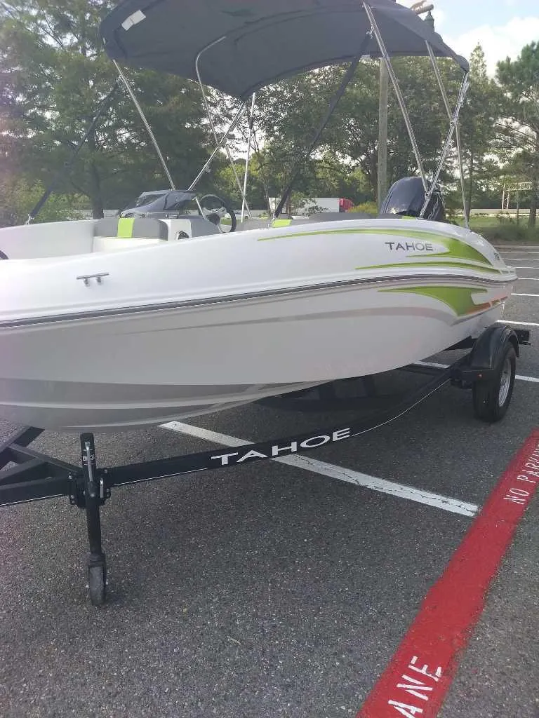 Slide: The Image of 2023 Tahoe T16 boat on trailer in parking lot. - 6