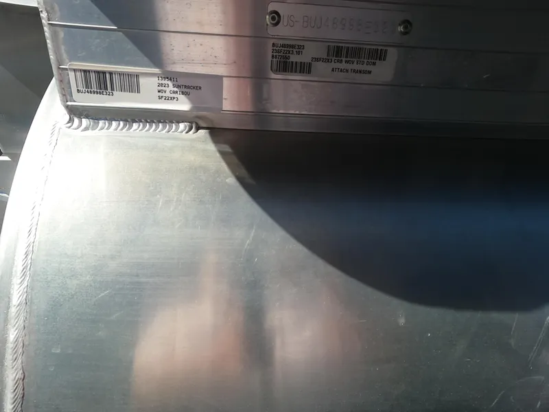 Slide: The Image of Close-up of 2023 Sun Tracker SportFish 22 XP3 boat's metal hull with serial numbers. - 12