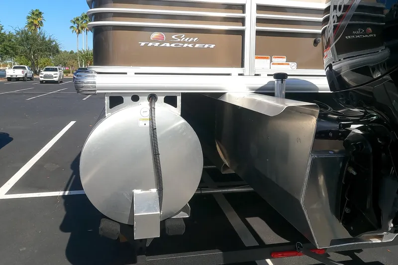 Slide: The Image of 2023 Sun Tracker SportFish 22 XP3 pontoon boat rear view in parking lot. - 14