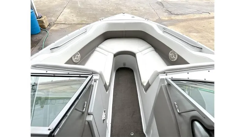 Slide: The Image of 2006 Cobalt 220 Bow boat interior with cushioned seating and speakers. - 4