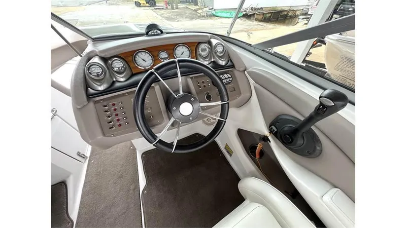 Slide: The Image of 2006 Cobalt 220 Bow boat dashboard with steering wheel and control panel. - 8