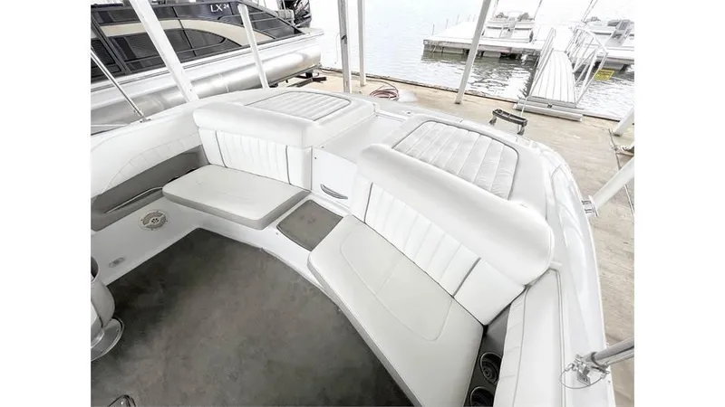 Slide: The Image of 2006 Cobalt 220 Bow boat interior with white cushioned seating. - 9