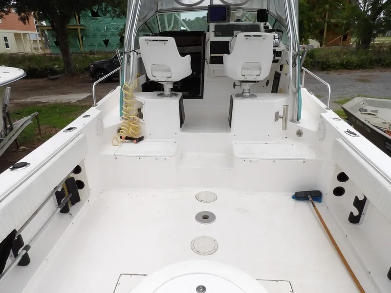 Slide: The Image of 1997 Hydra-Sports 2750 WA boat interior with white seating and fishing equipment. - 18
