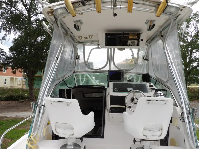 Slide: The Image of 1997 Hydra-Sports 2750 WA boat interior with helm, steering wheel, and seating. - 19