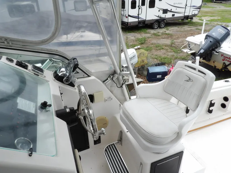Slide: The Image of 1997 Hydra-Sports 2750 WA boat interior with steering wheel and captain's chair. - 21