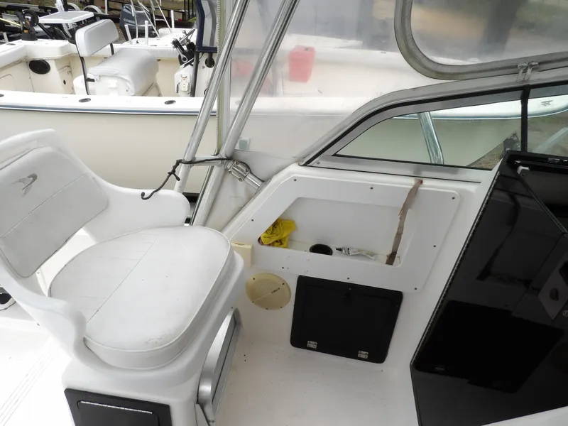 Slide: The Image of 1997 Hydra-Sports 2750 WA boat interior with white seating and storage compartments. - 22