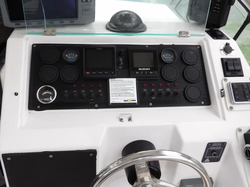 Slide: The Image of Dashboard of a 1997 Hydra-Sports 2750 WA boat with navigation instruments and controls. - 26