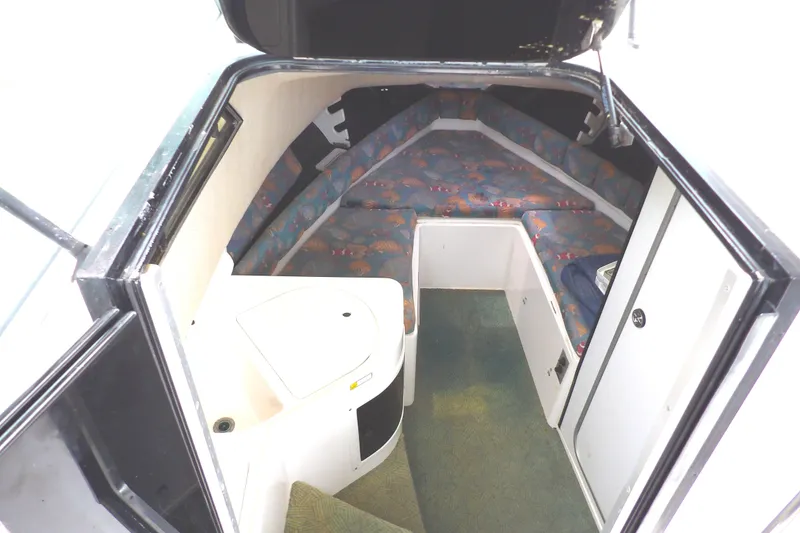 Slide: The Image of 1997 Hydra-Sports 2750 WA cabin interior with seating and compact amenities. - 28
