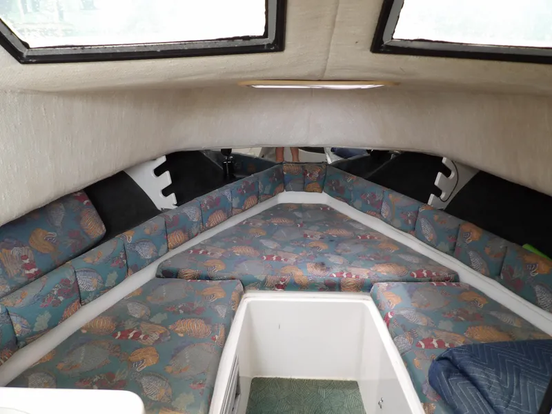 Slide: The Image of 1997 Hydra-Sports 2750 WA cabin interior with patterned seating and windows. - 29