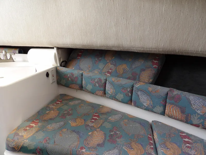 Slide: The Image of 1997 Hydra-Sports 2750 WA cabin interior with patterned cushions and compact design. - 30